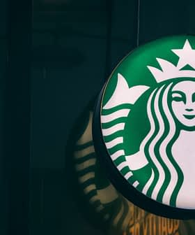 Starbucks logo sign featuring a green background and a white mermaid emblem with a crown. - Olive Oil Times
