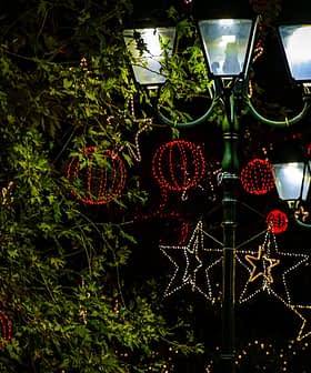Street lamps adorned with decorative lights and ornaments during the holiday season. - Olive Oil Times