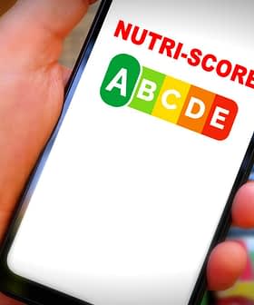 Hand holding a smartphone displaying the Nutri-Score logo with letters A to E in colored boxes. - Olive Oil Times