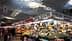 Market stall displaying a variety of fruits and vegetables under a large ceiling structure. - Olive Oil Times