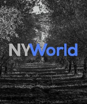 Black and white image of an olive grove with the NYWorld logo overlayed in blue and gray. - Olive Oil Times