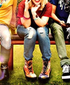 Five young individuals sitting on a bench, each wearing different styles of clothing and footwear. - Olive Oil Times