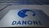 Danone company logo displayed on a building facade with a blue silhouette of a child's profile. - Olive Oil Times