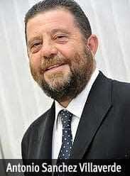 Man with a beard wearing a suit and tie, smiling at the camera. - Olive Oil Times