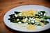 Plate of cooked asparagus topped with chopped egg and grated cheese. - Olive Oil Times