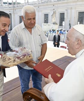 Two men presenting gifts to Pope Francis during a meeting at the Vatican. - Olive Oil Times
