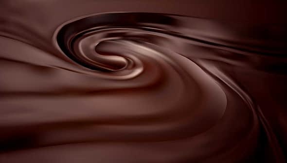 Smooth, swirling texture of dark chocolate with a glossy finish. - Olive Oil Times